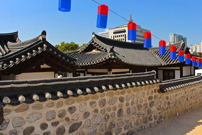 Lanterns hanging over retaining wall at temple