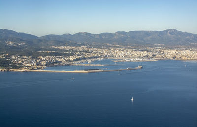 Aerial view of sea and mountains against sky