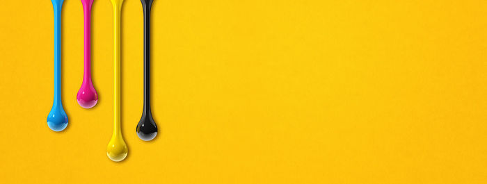 High angle view of multi colored pencils on yellow background