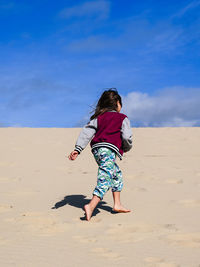 Full length of woman on beach against sky