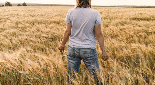 Rear view of man standing on field