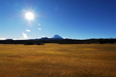 Scenic view of mountains against blue sky