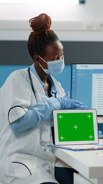 Doctor showing digital tablet at hospital
