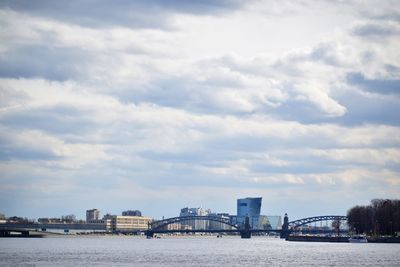 Bridge over river against buildings in city