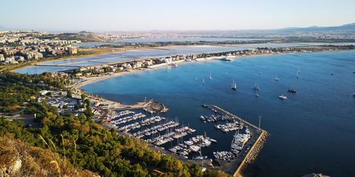 High angle view of cityscape by sea against sky