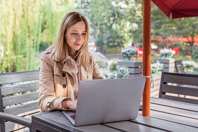 Smiling woman using laptop at home