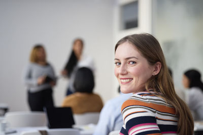 Portrait of smiling woman in class