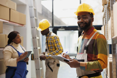 Rear view of people working at construction site