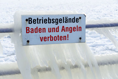 Close-up of warning sign on snow