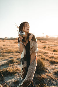 Full length of woman wearing sunglasses against clear sky