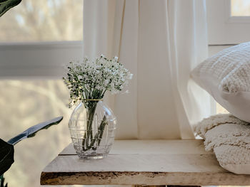 Close-up of white flower vase on table at home