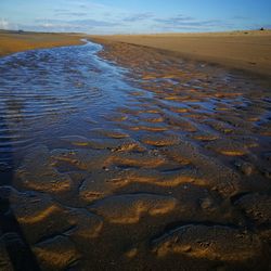 High angle view of wet beach during sunset