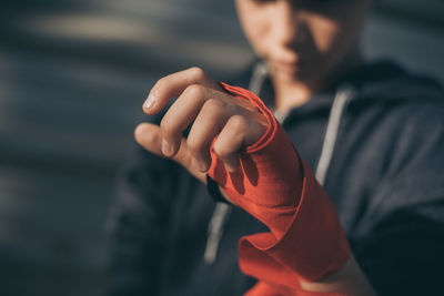 Close-up of boy wearing band on hand