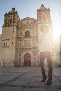 Full length of man standing outside historic building