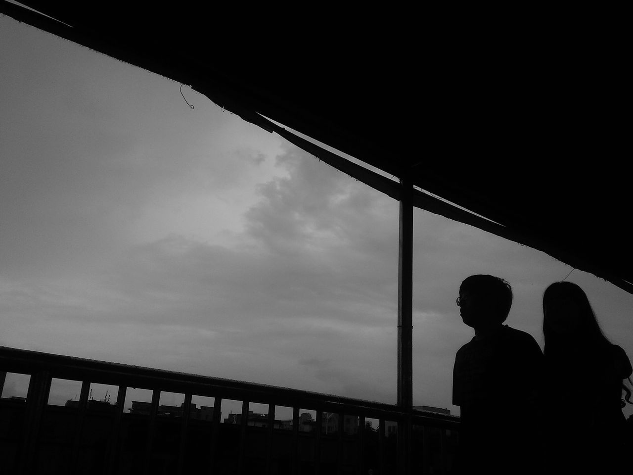 silhouette, sky, men, low angle view, lifestyles, built structure, architecture, leisure activity, sunset, railing, standing, person, indoors, outline, cloud - sky, unrecognizable person, dusk