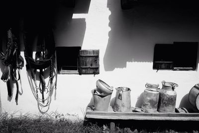 Milk canisters on shelf against farm