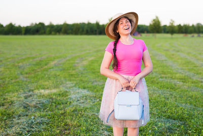 Full length of woman standing on field