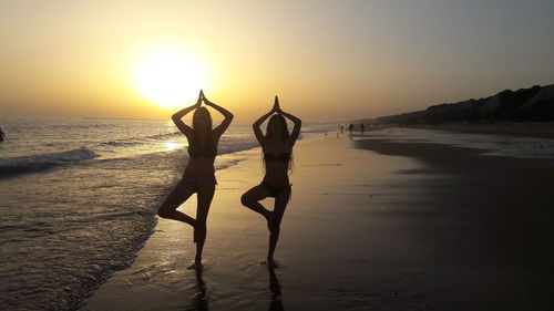 Women on beach at sunset