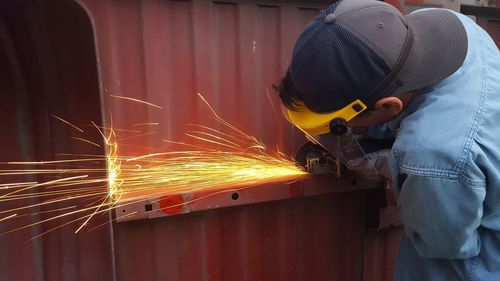 Low angle view of worker working at factory