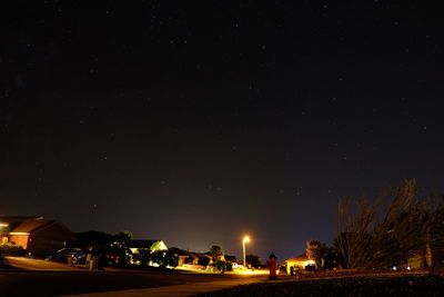 Illuminated building against sky at night