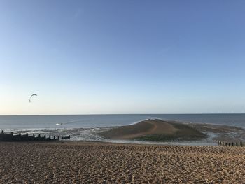 Scenic view of beach against clear blue sky