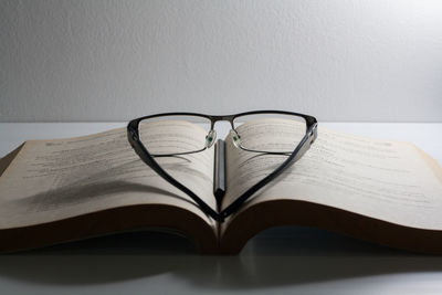 Close-up of eyeglasses on book