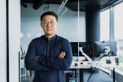 Portrait of businessman standing in cafe