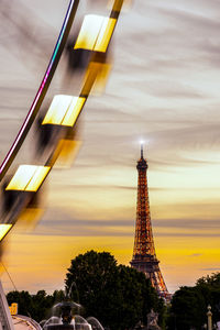 Low angle view of illuminated tower against sky