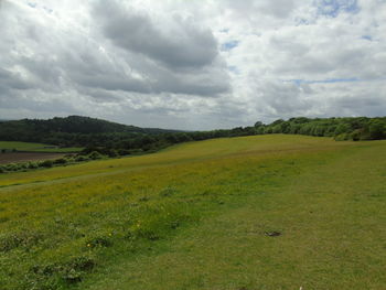 Scenic view of golf course against sky