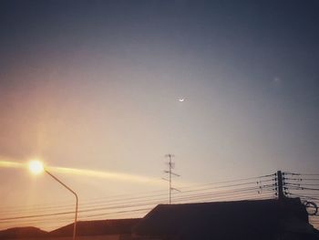 Low angle view of silhouette roof against sky during sunset