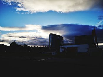 Silhouette buildings against sky in city