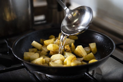 Woman cooking a vegetable soup with pumpkin, potato and onion. s