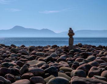 Rocks on beach against sky