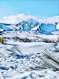 Scenic view of snowcapped mountains against sky