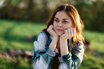 Portrait of young woman standing outdoors