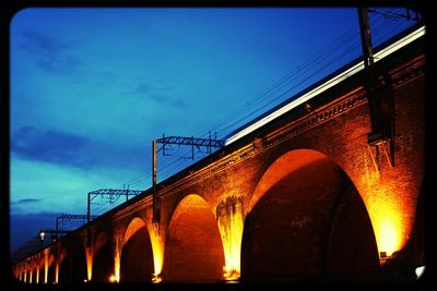 Low angle view of bridge against cloudy sky