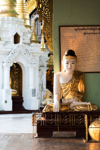 Portrait of young woman sitting in temple