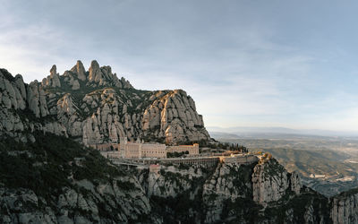 Panoramic view of historic building against rock formation