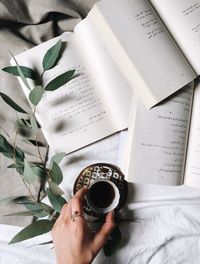 High angle view of hand holding coffee cup