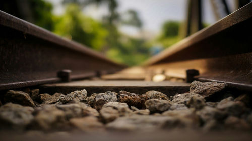 Close-up of stones at railroad tracks