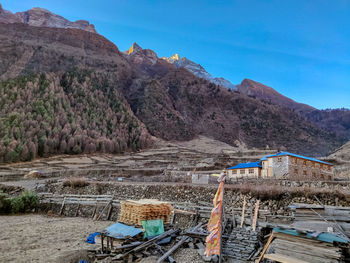 Scenic view of landscape and mountains against clear blue sky