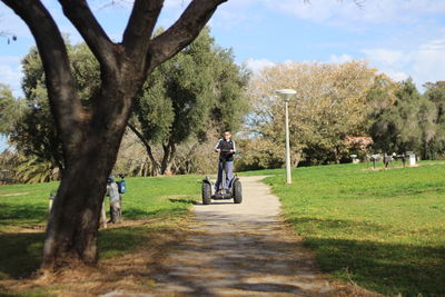 Boy riding bicycle on country road