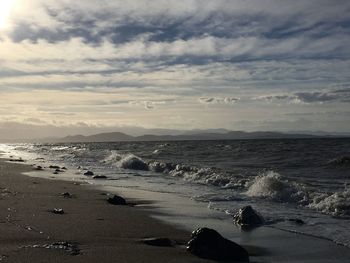 Scenic view of sea against cloudy sky