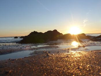 Scenic view of sea against clear sky during sunset
