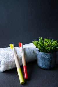 Close-up of multi colored pencils on table against black background