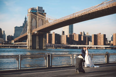 Bridge over river with city in background