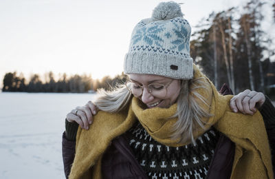 Portrait of a woman smiling wrapped up warm walking on a frozen lake