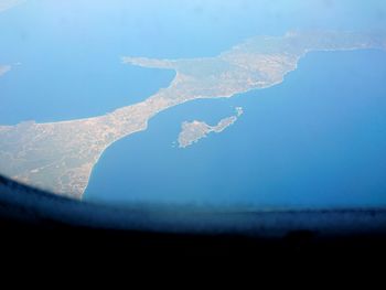 Aerial view of sea against clear blue sky