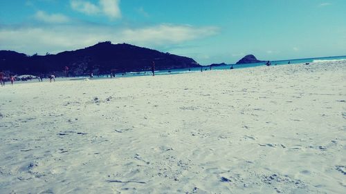 View of calm beach against blue sky