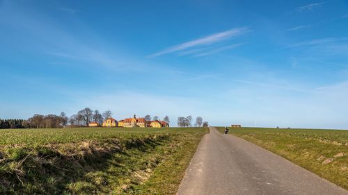 View of rural landscape against cloudy sky